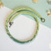 Green Fade Kumihimo necklace with soft ombré green glass seed beads, hand-braided in a long strand with a brass toggle clasp